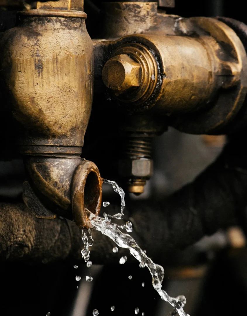 A close up of the water flowing out of a faucet.